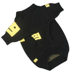 A black knit pet sweater with yellow graphic smiley face patches on the sleeves and body, shown against a plain white background.