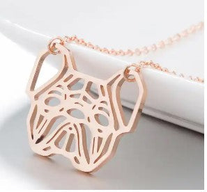 Rose gold pendant necklace with a cutout dog face design, hanging from a delicate chain against a white background.