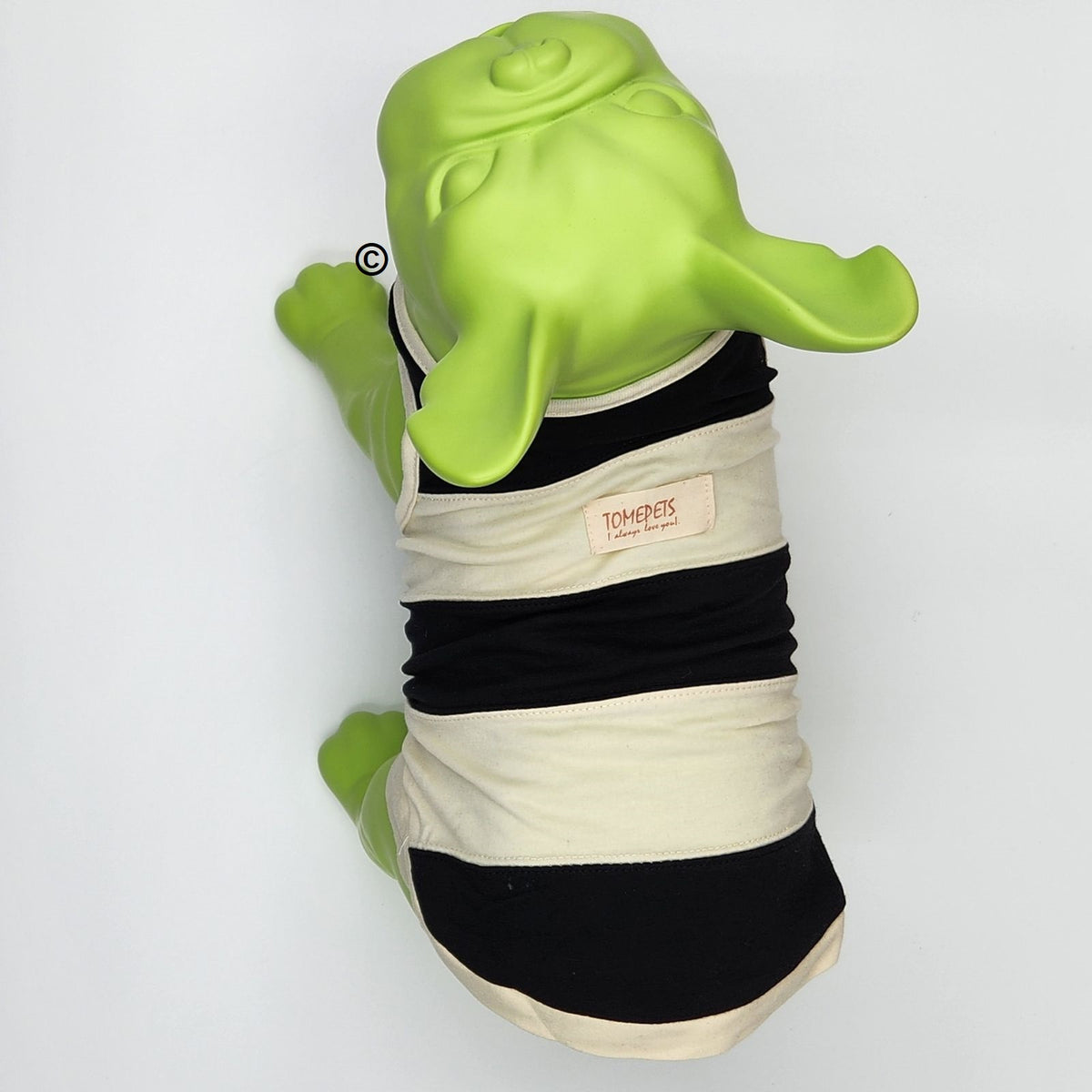 A dog tank top with black and cream horizontal stripes, displayed on a green plastic dog mannequin against a plain white background. The brand label reads 'TOMEPETS.